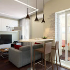 Three dark Clérachic pendants over a round-ended white table with bar stools, in a living room with a grey sofa.
