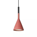 Front view of a Clérachic pendant in a coral-red concrete shade on white, with a black collar and a glowing opening.