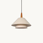 A two-tier linen pendant from Clérachic with a turned wooden neck and a black cord, on a plain off-white backdrop.