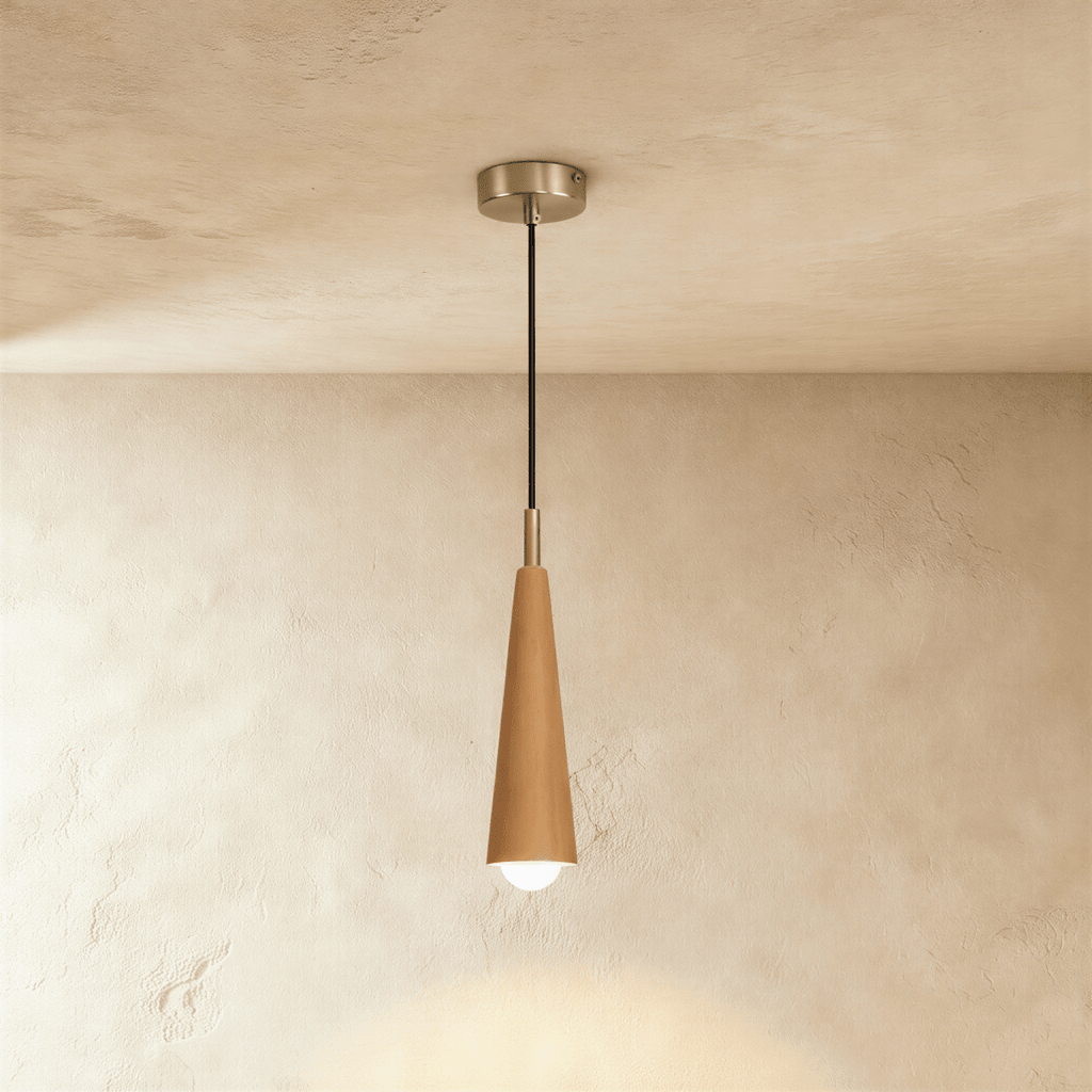 Clérachic tapered wooden cone pendant in a light natural finish with a silver-tone canopy and a bare globe bulb, on limewash plaster.
