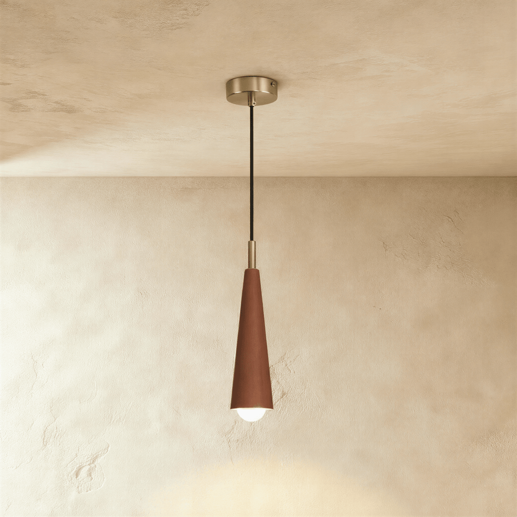 Clérachic tapered cone pendant in a deep reddish walnut finish with a silver-tone canopy and black cord against limewash plaster.