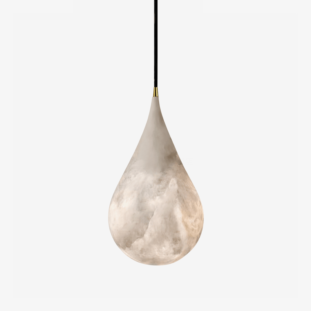 Veined alabaster drop shade on a black cord with a brass tip, from Clérachic, shown on a plain light backdrop.