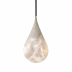 This Clérachic alabaster teardrop shade, slightly turned, with soft grey veins and a brass tip on a black cord.
