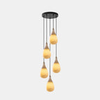 Five small lit alabaster drops hang at different heights from one round black canopy on this Clérachic cluster pendant.