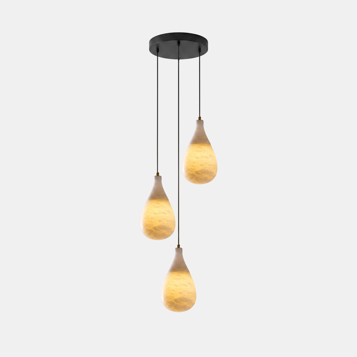 Three lit alabaster drops hang at different heights from a round black canopy on this Clérachic pendant.