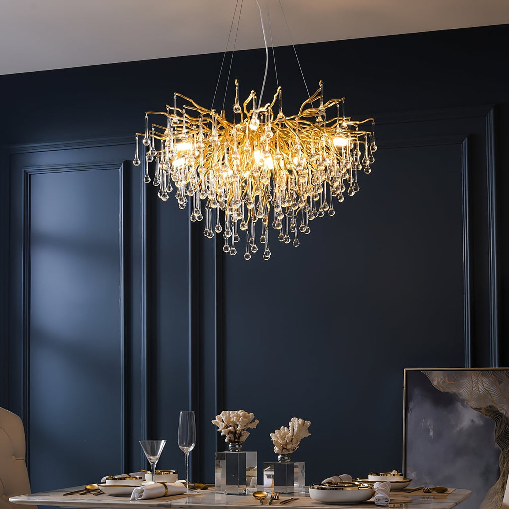 The Clérachic teardrop chandelier lit above a set table against deep navy panelling.