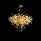 Clérachic teardrop chandelier on black, its gold branches spreading before the glass drops.