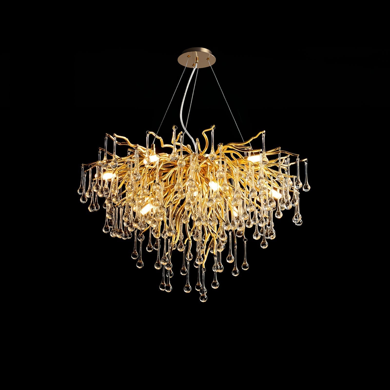 Clérachic teardrop chandelier on black, its gold branches spreading before the glass drops.