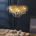 The Clérachic teardrop chandelier lit above a laid table beside a framed artwork.