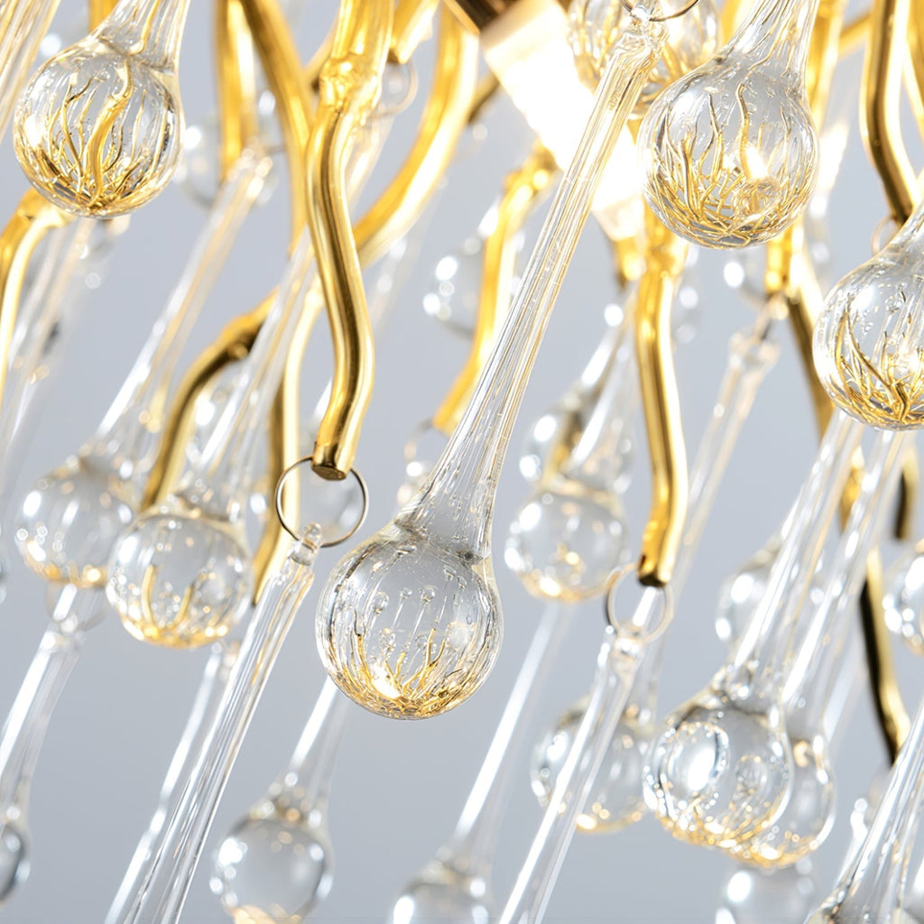 Macro of the Clérachic teardrop chandelier, showing the ribbed glass drops on gold hooks.