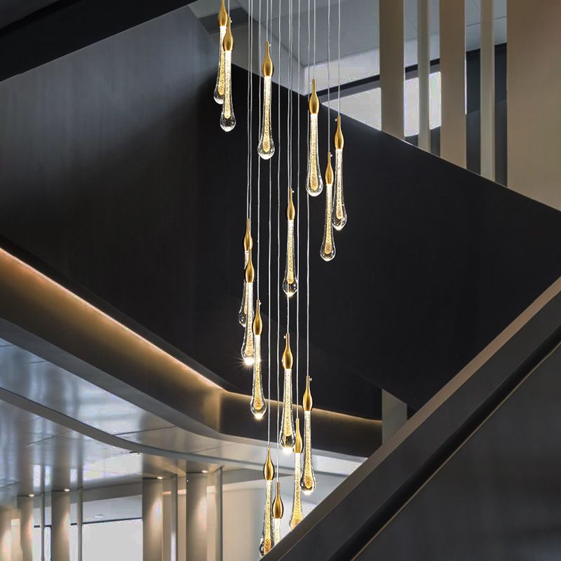 The 20-light Clérachic Teardrop Crystal Chandelier cascades in a stairwell with dark gray walls.