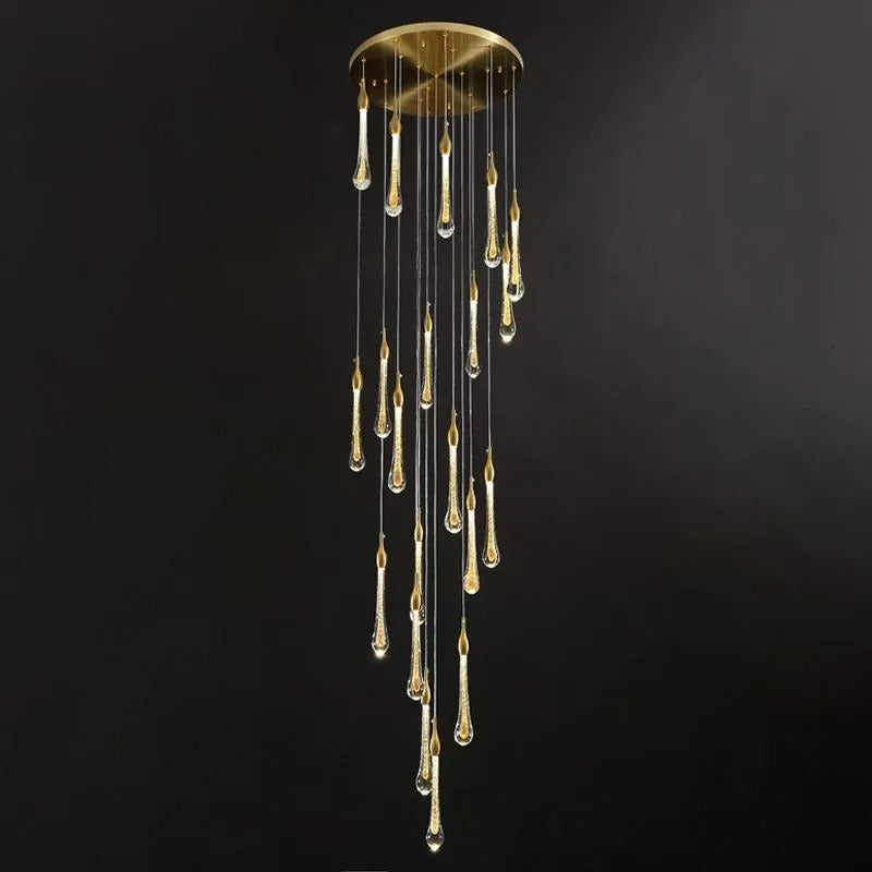 Twenty glowing drops on the Clérachic Teardrop Crystal Chandelier, gold finish against a dark backdrop.