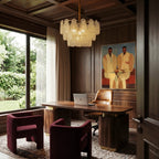 Clérachic round chandelier with frosted glass teardrop tiers above a walnut desk in a wood-panelled study.