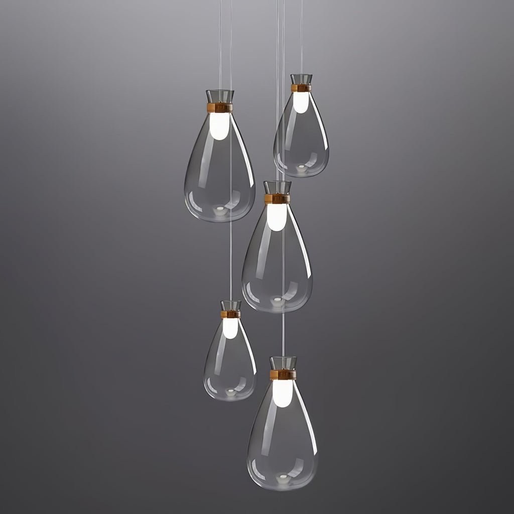 Five Clérachic teardrop pendants in clear grey-tinted glass hung at stepped heights against a dark grey backdrop.