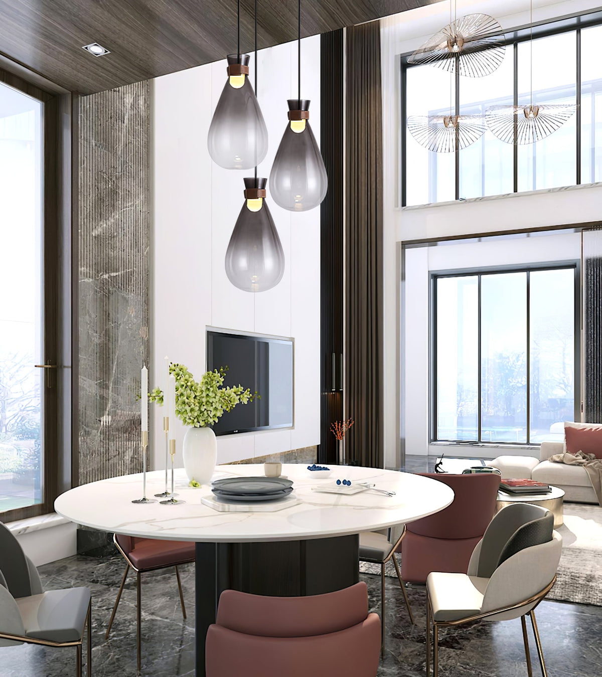 Three smoke-grey Clérachic teardrop pendants in a tall room with big windows, above a round marble table with pink chairs.