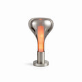 On white, a smoke-grey teardrop lamp with an orange glowing core stands on a round chrome base, from Clérachic.