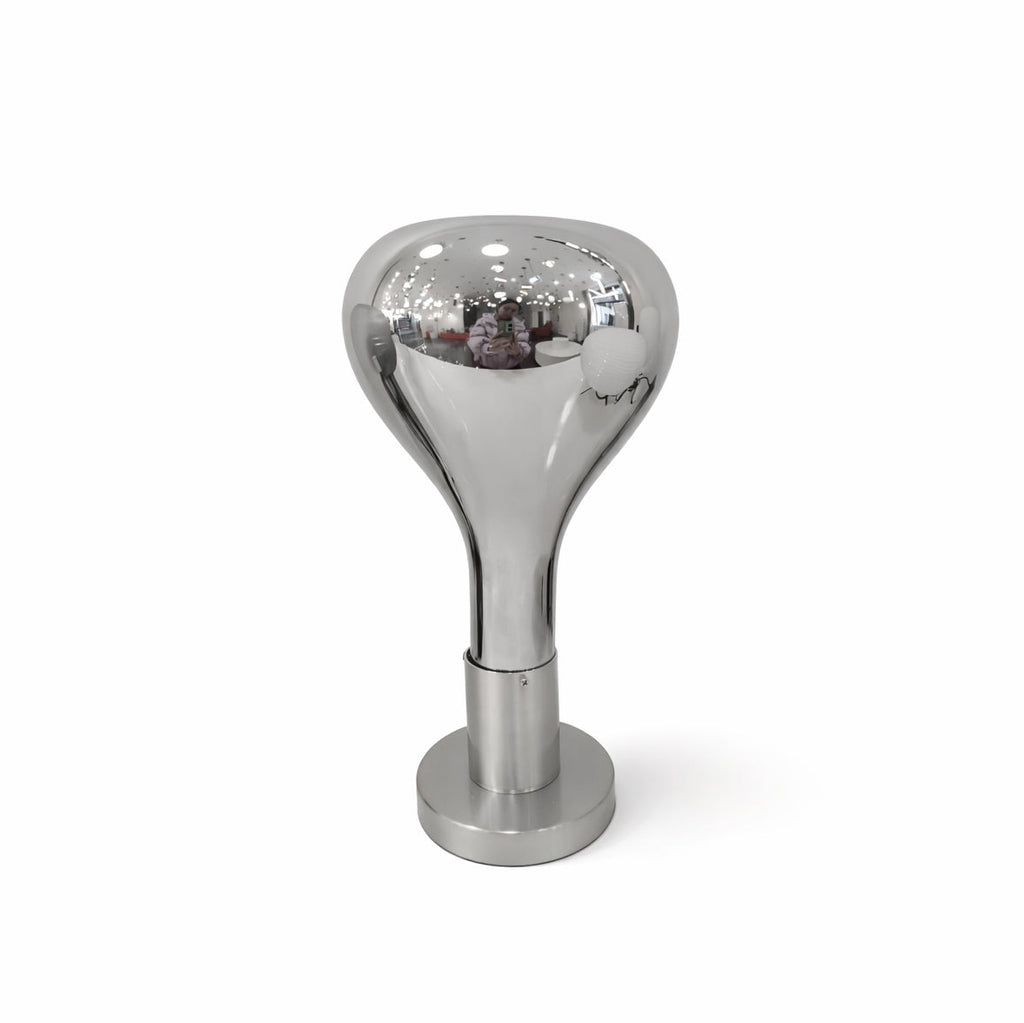 Studio view of a mirror-finish teardrop shade on a brushed chrome base, switched off, on a plain white backdrop, from Clérachic.