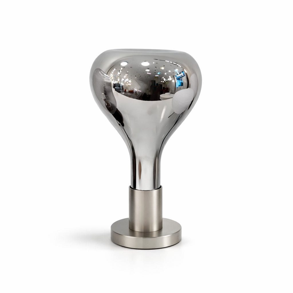 Close studio view of a mirror-chrome teardrop shade on a short brushed metal stem and round base, from Clérachic.