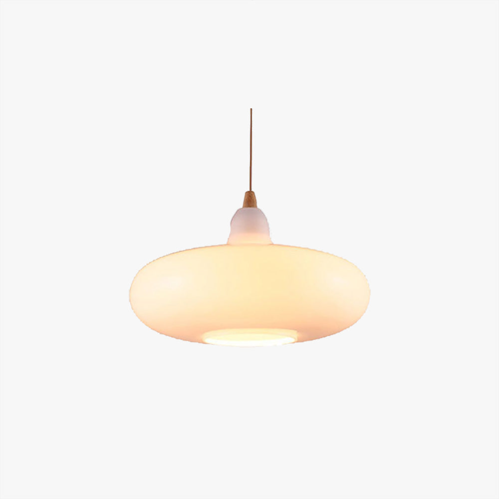 Studio shot of the Clérachic saucer pendant in white opal glass, lit on its slim cord against a plain backdrop.