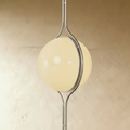 Clérachic floor-to-ceiling lamp in silver, angled to show the two opal halves meeting inside the ring.