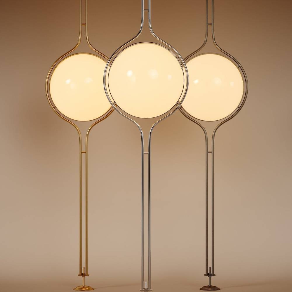 Clérachic floor-to-ceiling lamps shown together in brass, silver and vintage brass, each lit and standing on its small round floor foot.