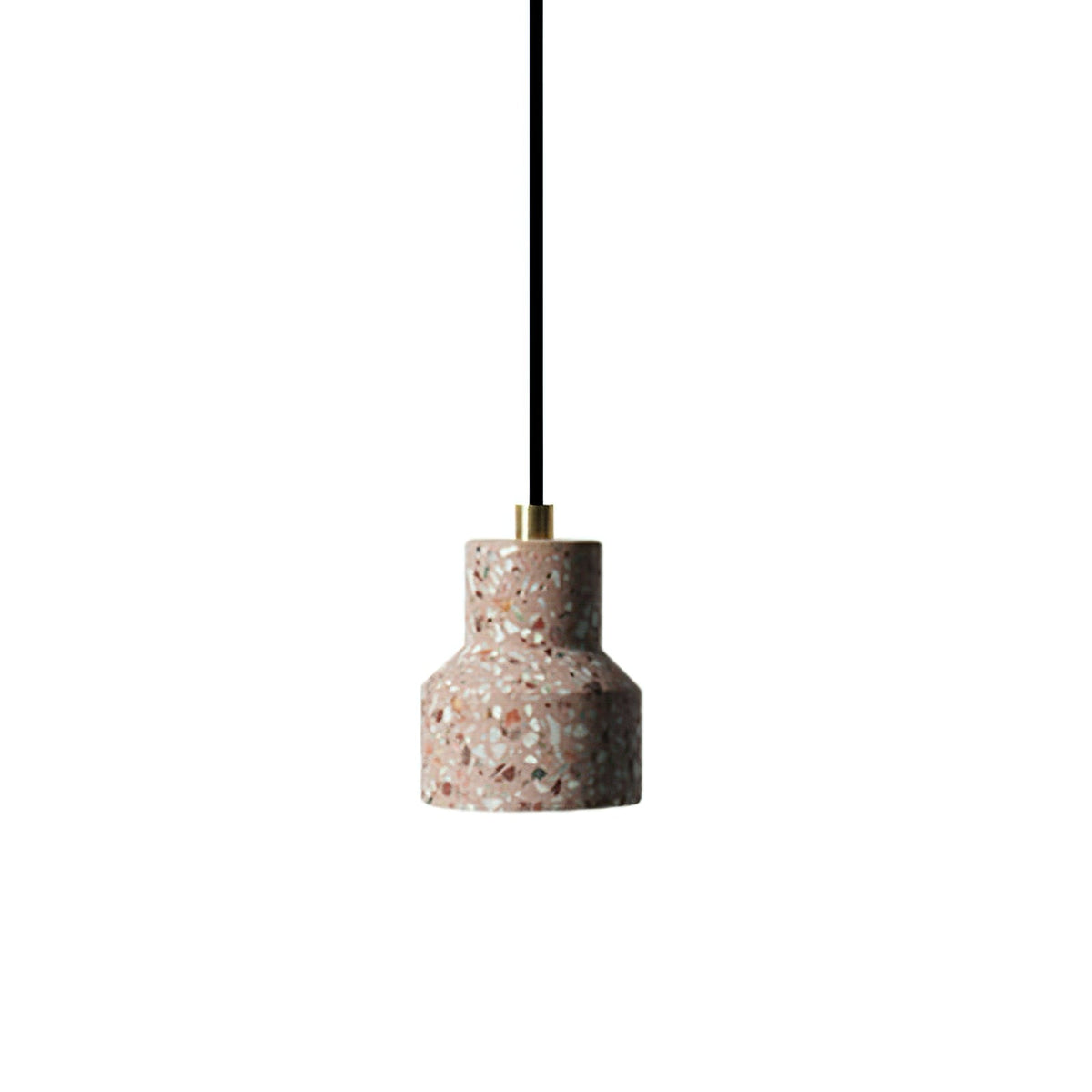 A single rose-toned terrazzo pendant from Clérachic hangs on a black cord with a brass top against a white backdrop.