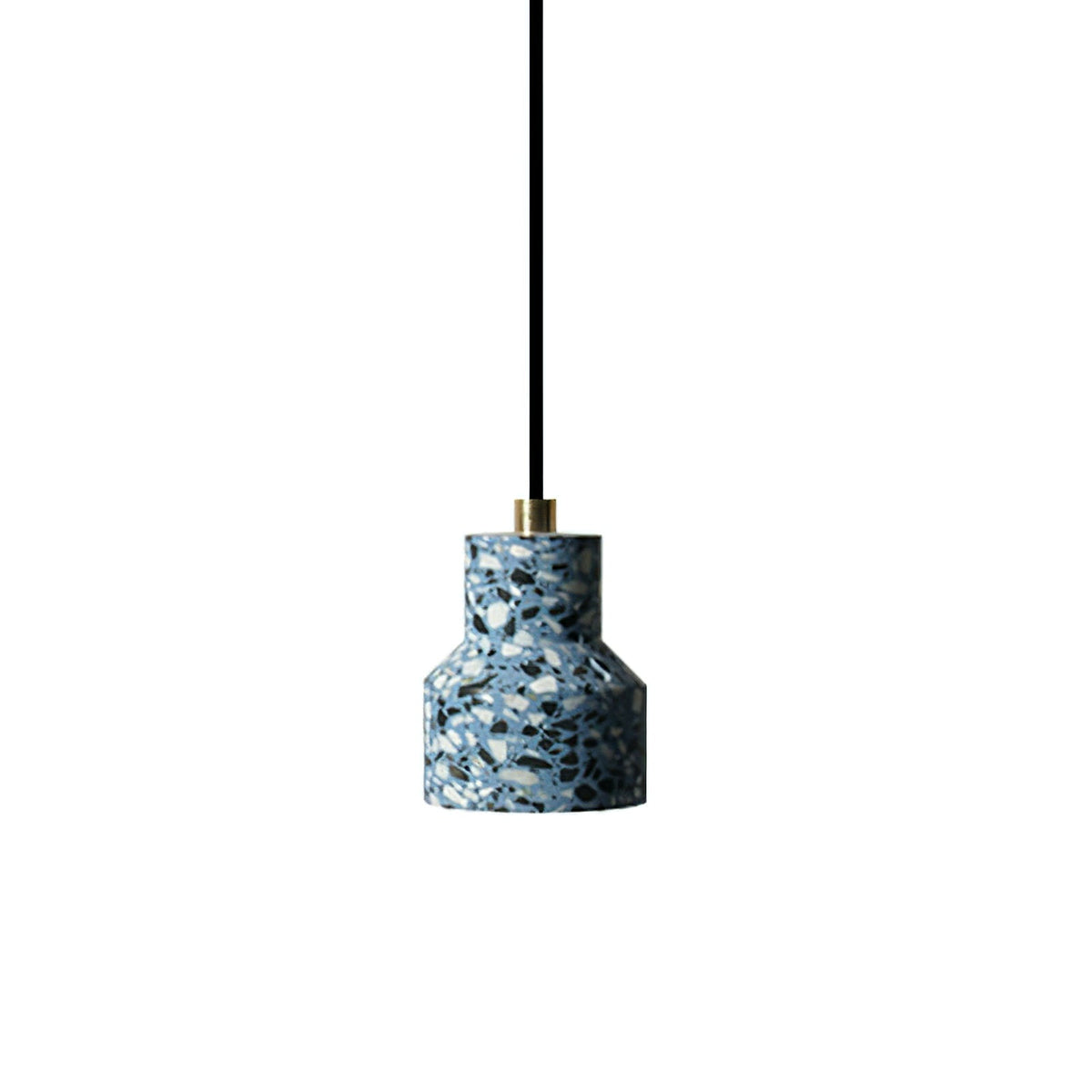 A single blue terrazzo pendant from Clérachic hangs on a black cord with a brass fitting, its shade flecked in white and navy chips.