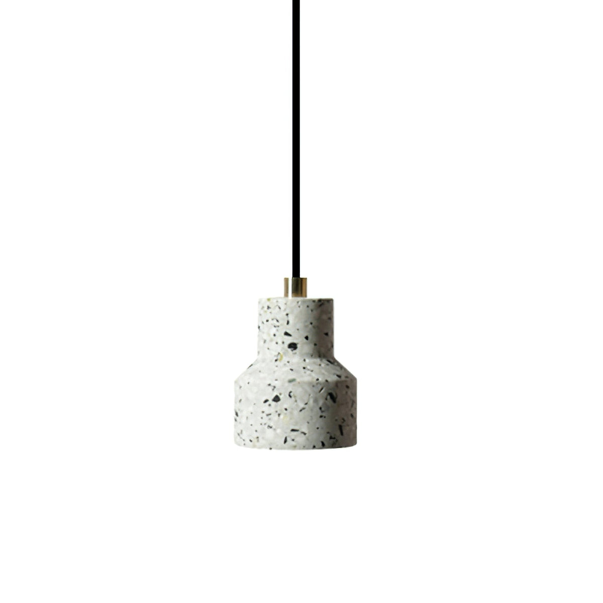 A single white terrazzo pendant from Clérachic hangs on a black cord with a brass fitting, its shade flecked with grey and black chips.