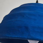Macro detail of the Clérachic Textured Blue Dome Pendant Light, showing the trowelled horizontal ridges across its matte cobalt surface.