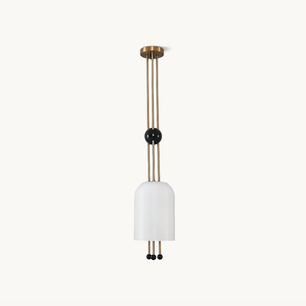 A Clérachic ribbed white cylinder pendant on a plain white backdrop, hung from a brass canopy on three brass rods with a black ball partway down.