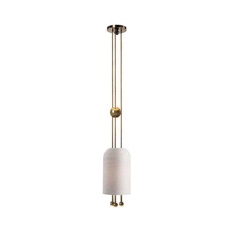 A Clérachic white pendant on a plain white backdrop, with a gold-toned ball on the rods and a small black canopy at the top.
