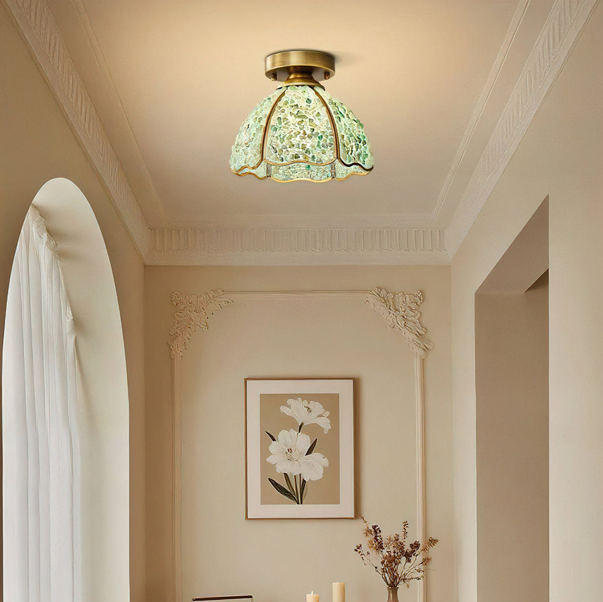 A green pebble-glass Clérachic ceiling light hangs close to the ceiling of a hallway with ornate cornice and an arched window.