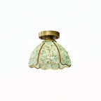 Green pebble-glass shade with a short brass stem and round canopy, this Clérachic flush light shown on a white background.