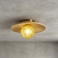 Close view of the spiral-grained bamboo disc and yellow ice-textured glass globe on this Clérachic ceiling light, on grey.