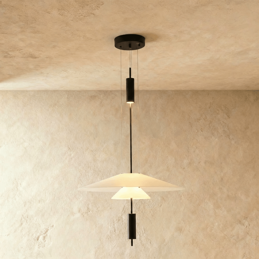 Clérachic pendant with a white frosted disc shade over a small glowing cone, suspended on fine wires from a black canopy.