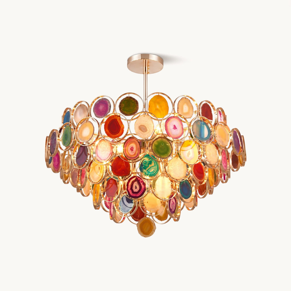 Multicolour agate chandelier from Clérachic on a plain white backdrop, with tiers of stone slices in gold-toned rings on a short ceiling rod.