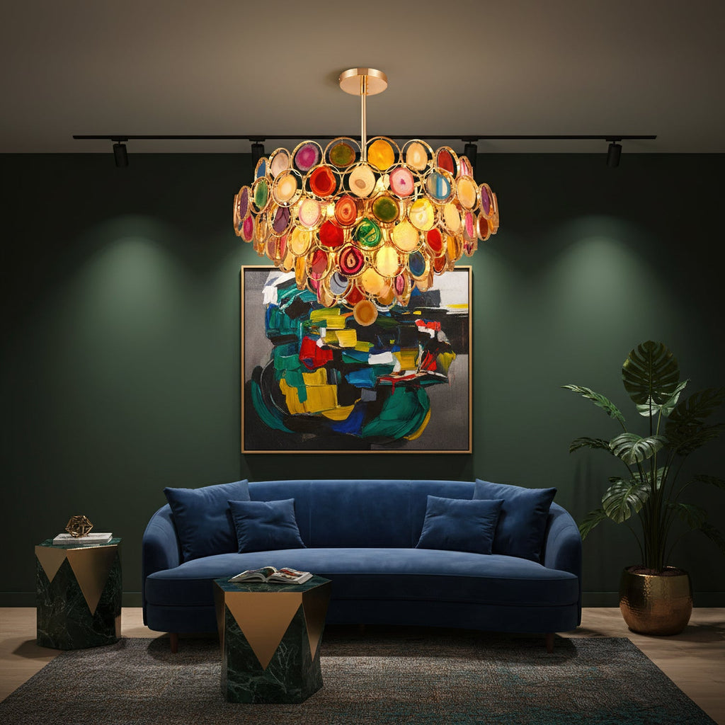 Clérachic multicolour agate chandelier lit above a navy sofa, in front of an abstract painting on a deep green wall.