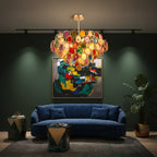 Clérachic multicolour agate chandelier lit above a navy sofa, in front of an abstract painting on a deep green wall.