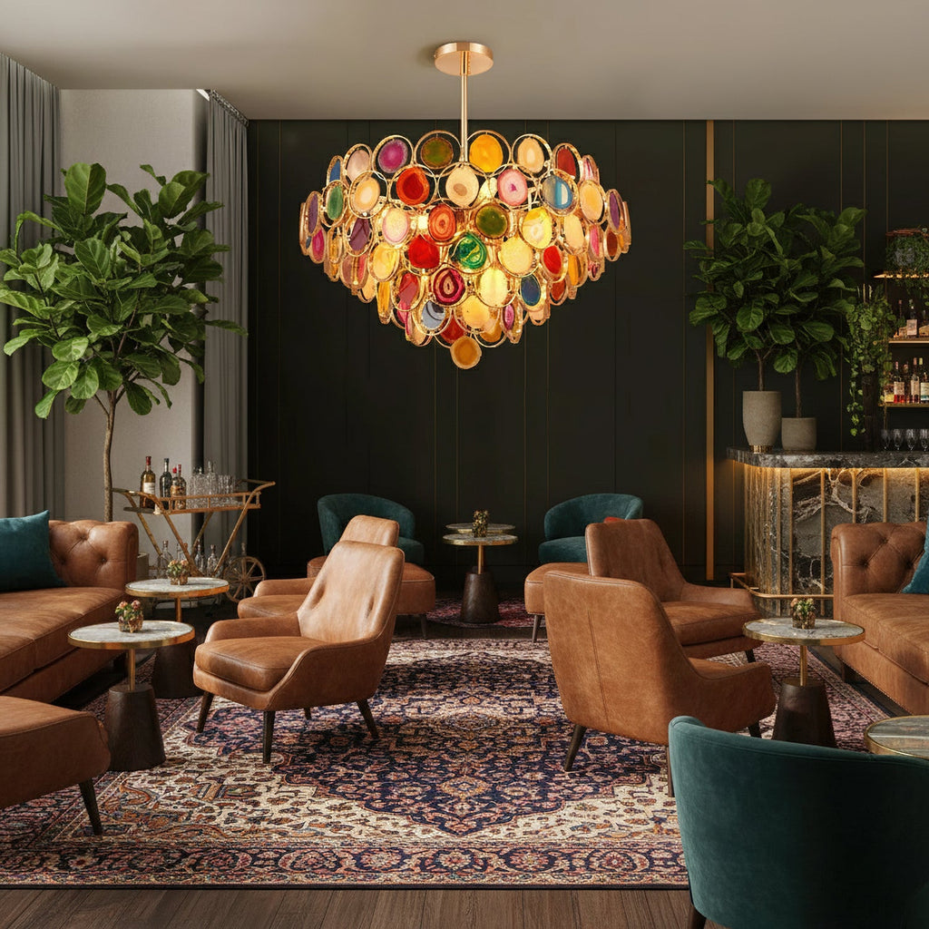 This Clérachic agate chandelier glows in a lounge with tan leather armchairs, a patterned rug and tall green plants.