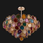 Clérachic agate chandelier on a black background, showing the rose-gold canopy, rod and tiers of coloured stone.