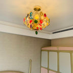 Clérachic agate chandelier lit close to the ceiling of a room with a pink wardrobe, casting a warm glow upwards.