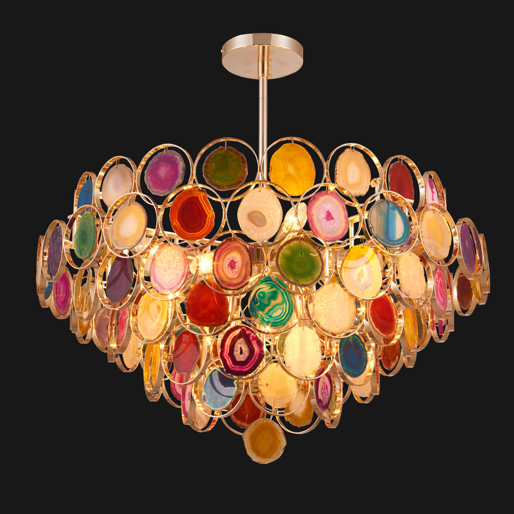 Multicolour Clérachic agate chandelier on a black background, the lit stone slices bright against the dark.