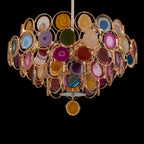 Clérachic agate chandelier on a black background, showing coloured stone slices in gold rings and a pendant slice below.