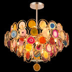 Clérachic agate chandelier on a black background, with warm light inside and a single amber slice hanging beneath.