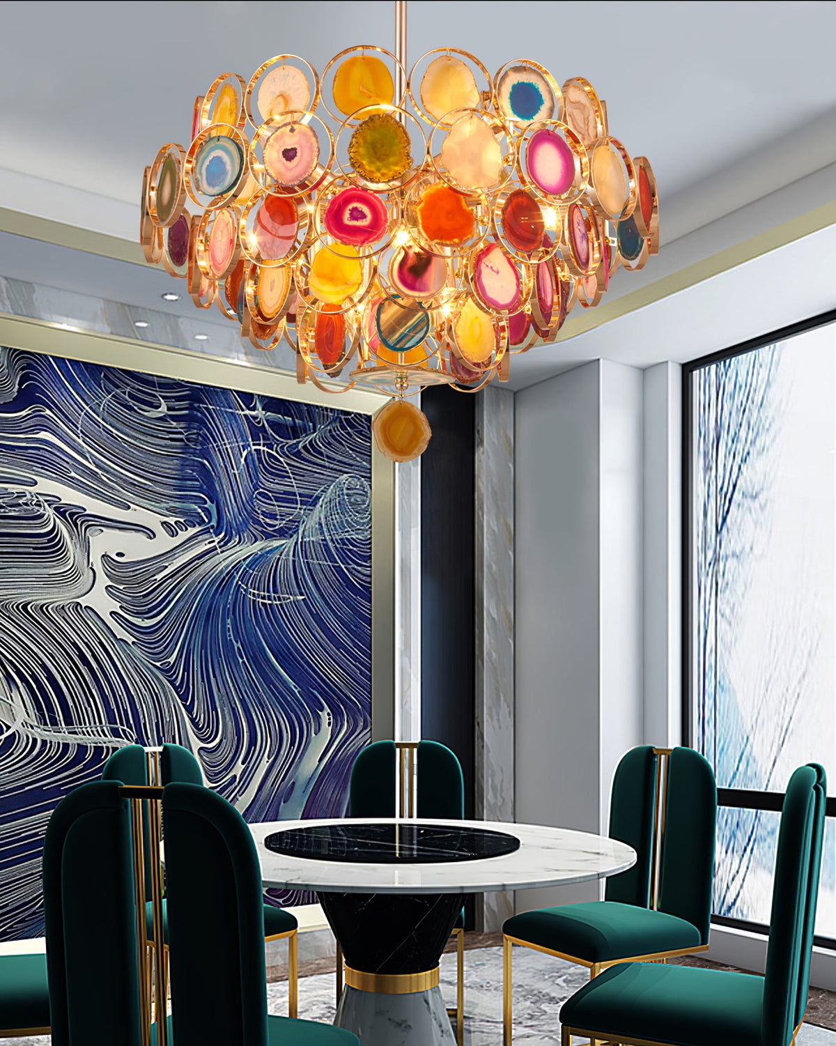 This Clérachic agate chandelier hangs above a round marble table with green chairs, near a blue patterned wall.