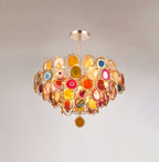 Slightly smaller view of this Clérachic agate chandelier on a soft grey wall, showing the rod and one hanging slice.