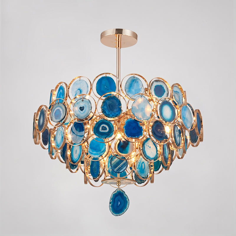 Clérachic agate chandelier in blue tones on a grey backdrop, its slices ranging from pale to deep blue.