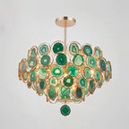 A Clérachic agate chandelier in green tones on a grey backdrop, its slices ranging from pale mint to forest green.