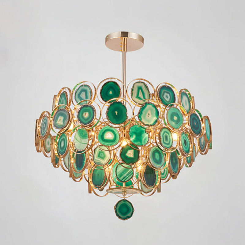 A Clérachic agate chandelier in green tones on a grey backdrop, its slices ranging from pale mint to forest green.