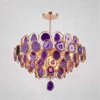 A Clérachic agate chandelier in purple tones on a grey backdrop, its slices ranging from lilac to deep violet.